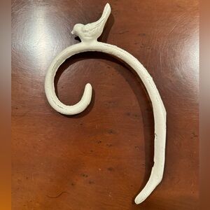 From Anthropologie, distressed white metal hook for your hanging basket